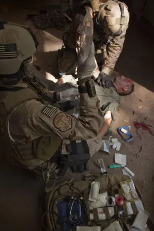 Posterazzi PSTTWE300025MLARGE U.S. Air Force CSAR parajumpers Giving First aid Poster Print, 23 x 34
